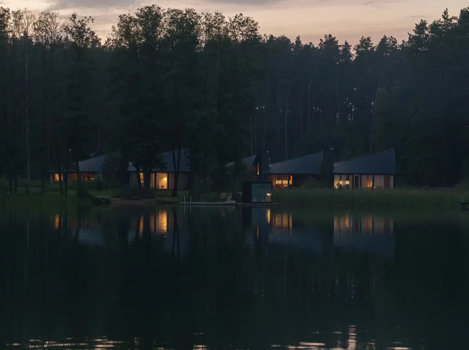 KONGA Village cabins at the lake shore at dusk
