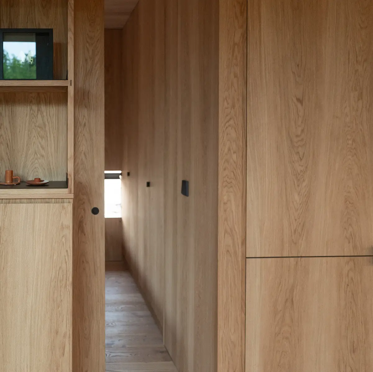 Light oak interior wall panels and storage in a KONGA cabin at Eco by Nature